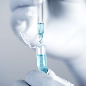 Close up a scientist working in laboratory to analyze blue extracted of DNA  molecules in micro tube , clinical or science testing analysis concept