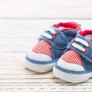 Baby shoes on wood background